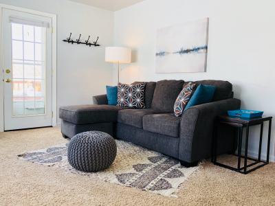 A comfy living room invites you to sit down and enjoy the mountain view out the big front windows.